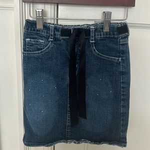 Girl’s denim skirt with rhinestones and ribbon bow